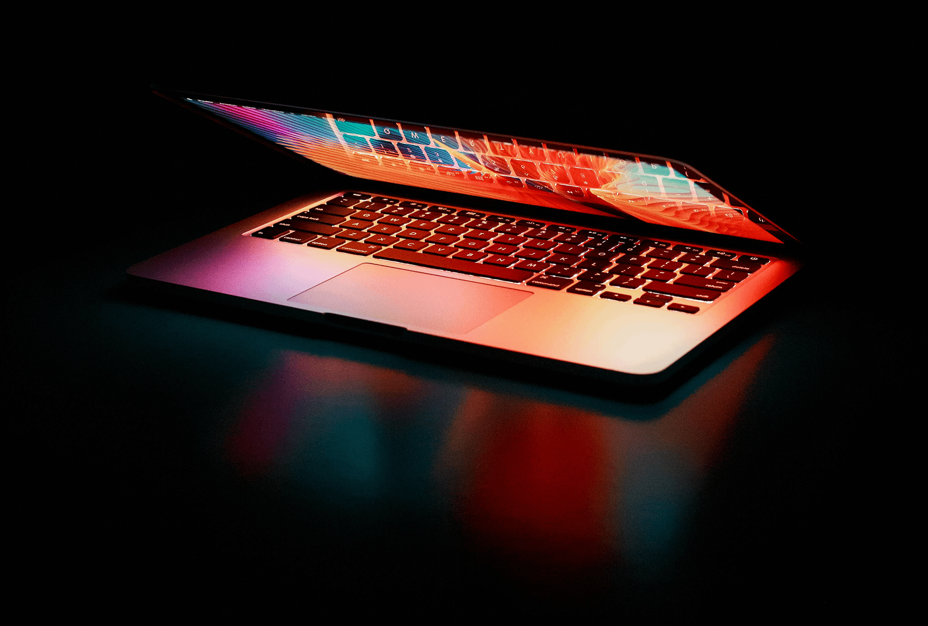 computer with glowing screen on a black background