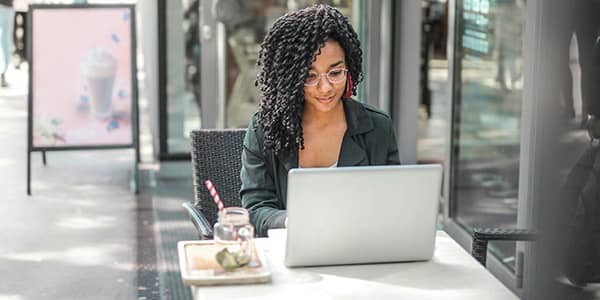 business woman sitting outside at computer